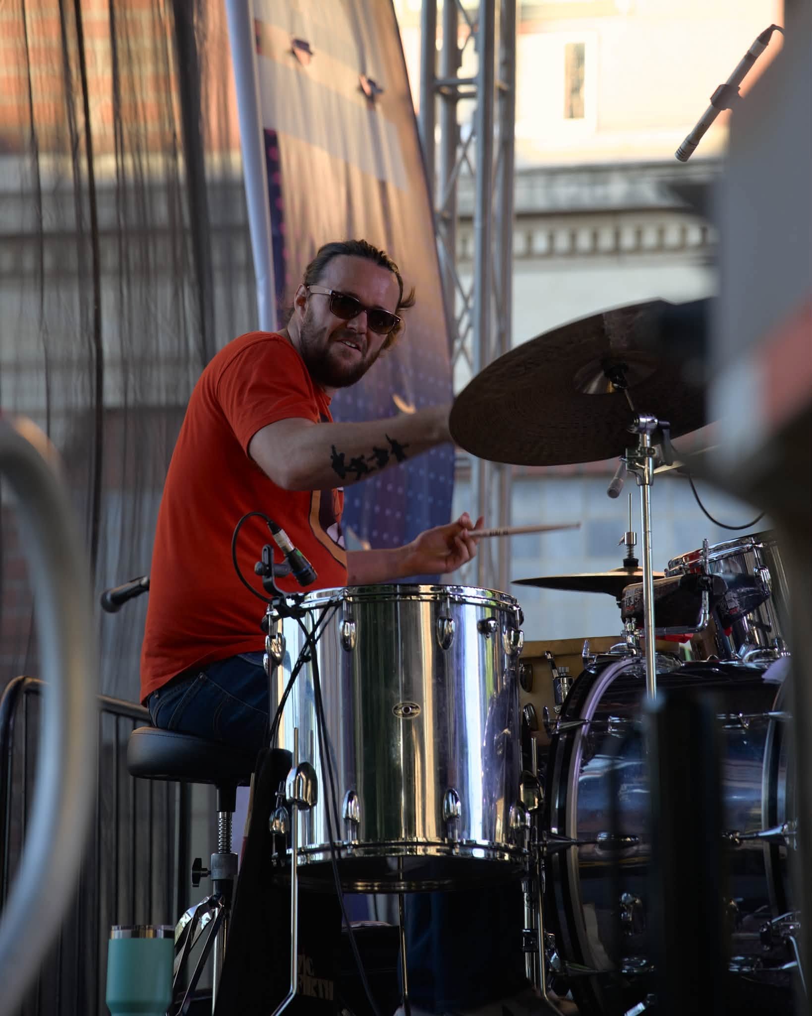 The drummer performing with the band